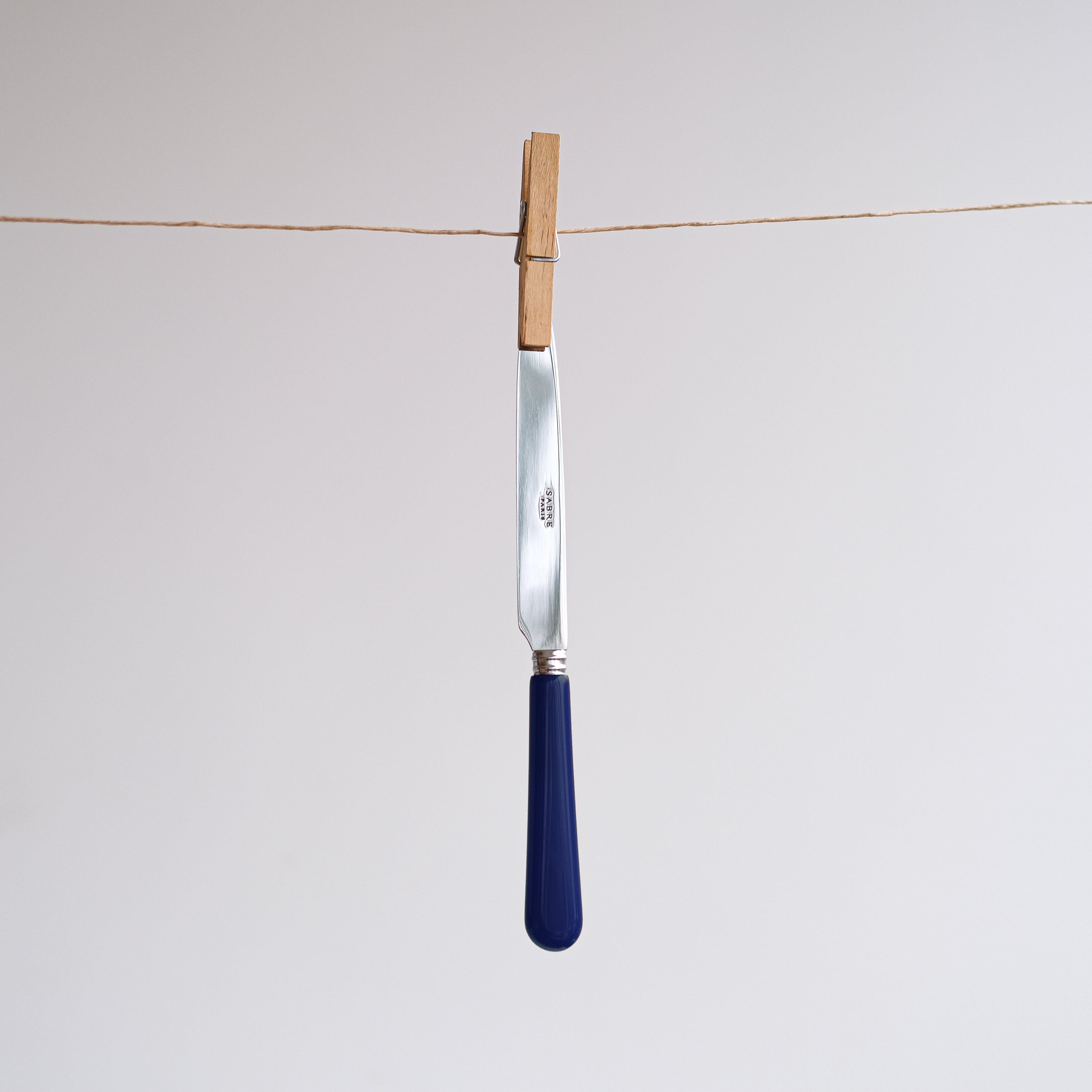 Navy Cutlery Set of 5: A stylish knife on a clothesline.