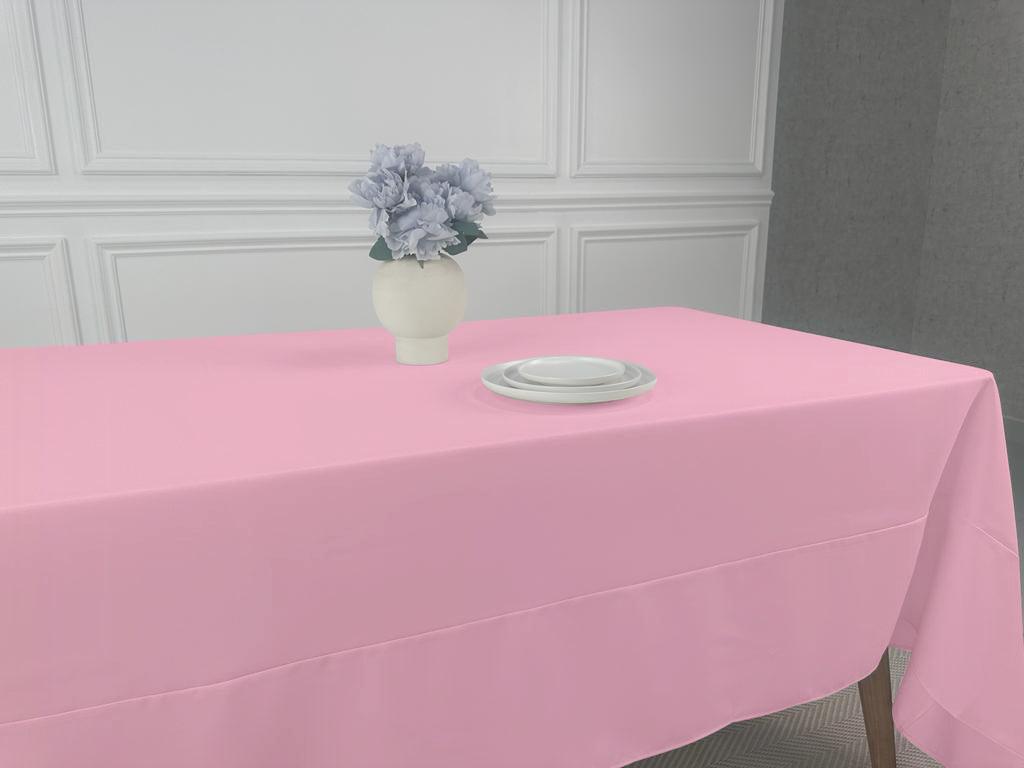 A pink tablecloth with a vase of flowers and plates on it, perfect for any table setting. Made of polyester fabric, this Polycotton Tablecloth is lightweight and easy to wash and reuse. Available in multiple colors and sizes. Ideal for weddings, dinner parties, birthdays, and special occasions.