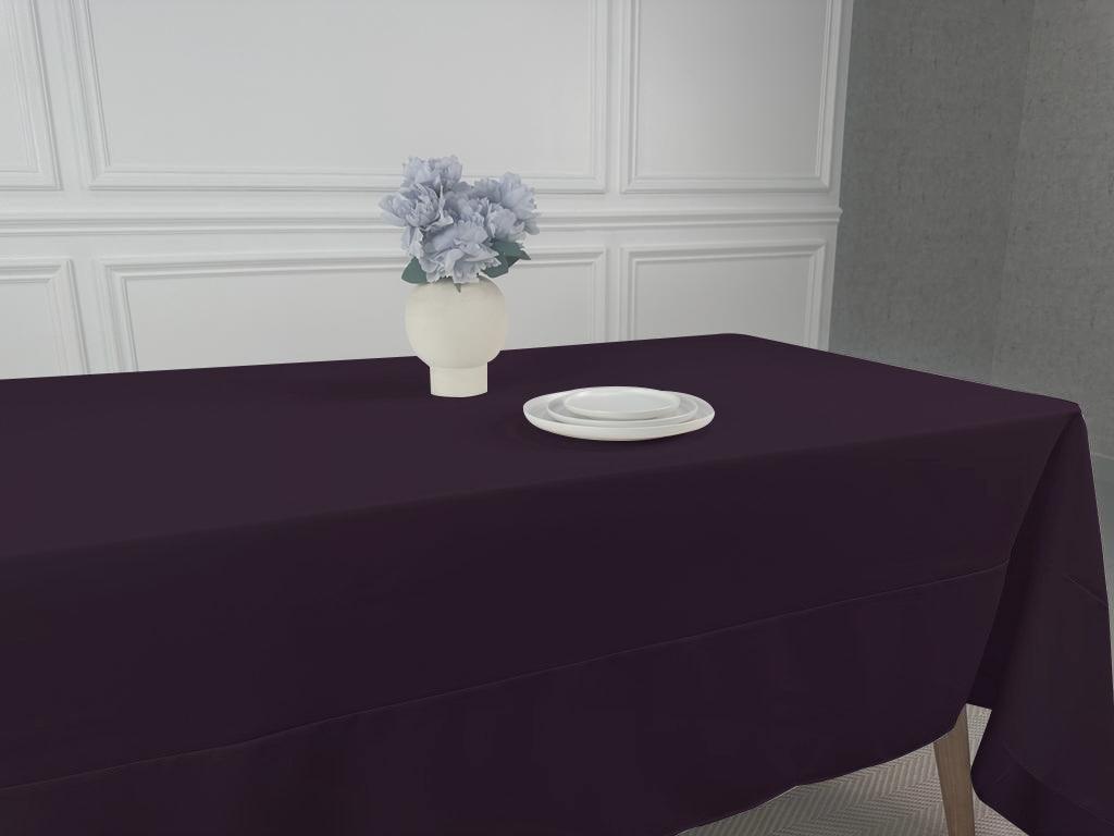 A Polycotton Tablecloth with a floral centerpiece on a table