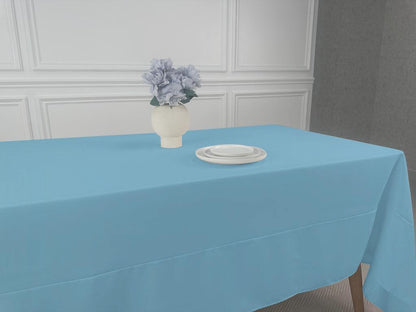 A Polycotton Tablecloth with a vase of flowers and white plates on it.