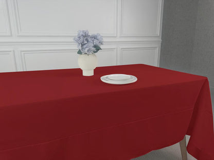 A table set with a vase of flowers and tableware
