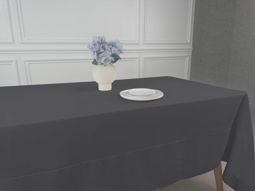 A Polycotton Tablecloth with a vase of flowers as a centerpiece.