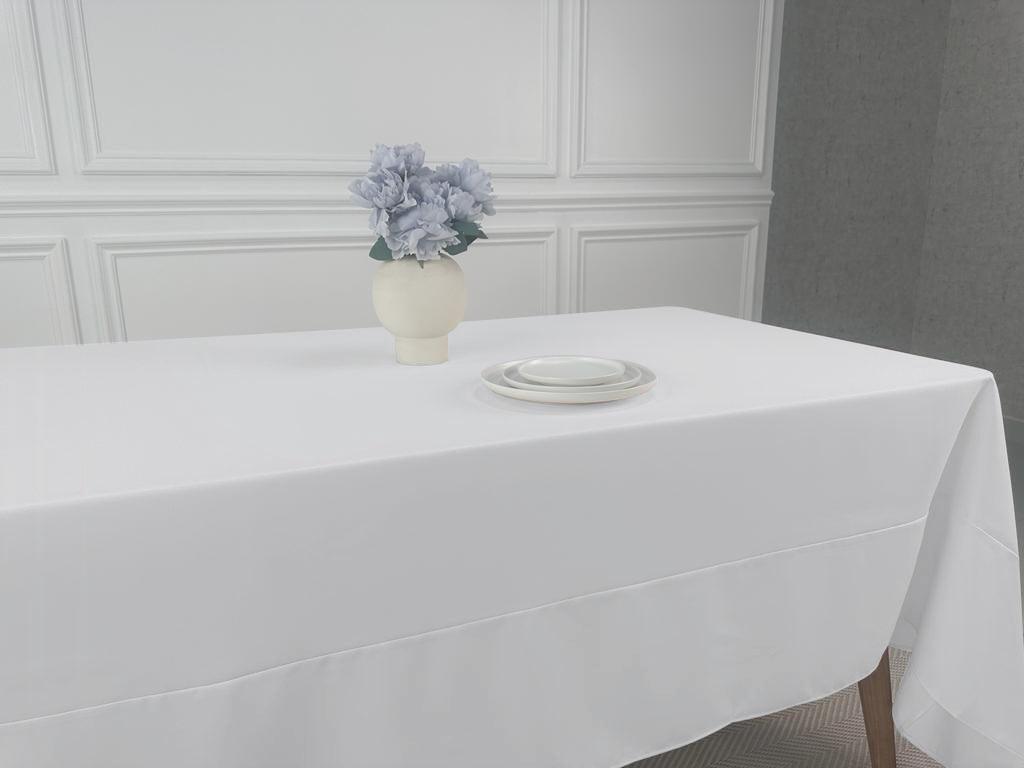 A Polycotton Tablecloth with a vase of flowers on it, perfect for any table setting. Lightweight and easy to wash, it adds a touch of elegance to your dining table linens. Available in 3 sizes.