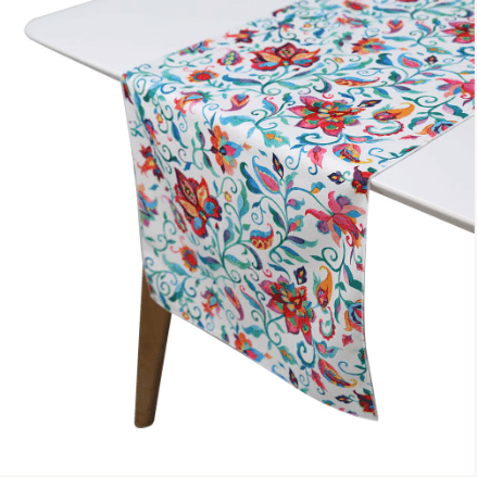 A Summer Florals polyester linen runner on a table.