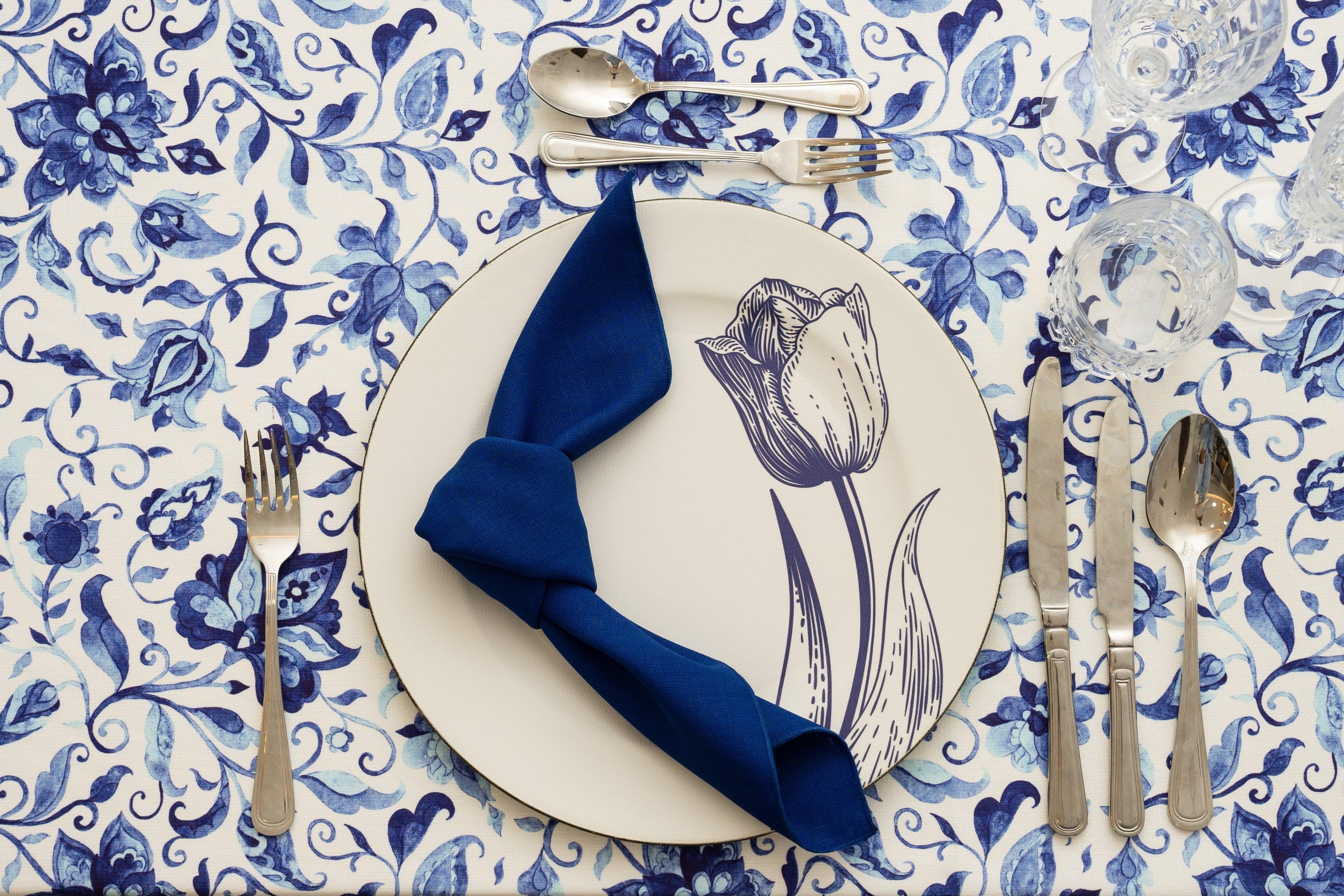 A plate with silverware and a napkin on a table, showcasing the Summer Florals Polyester Linen Tablecloth.